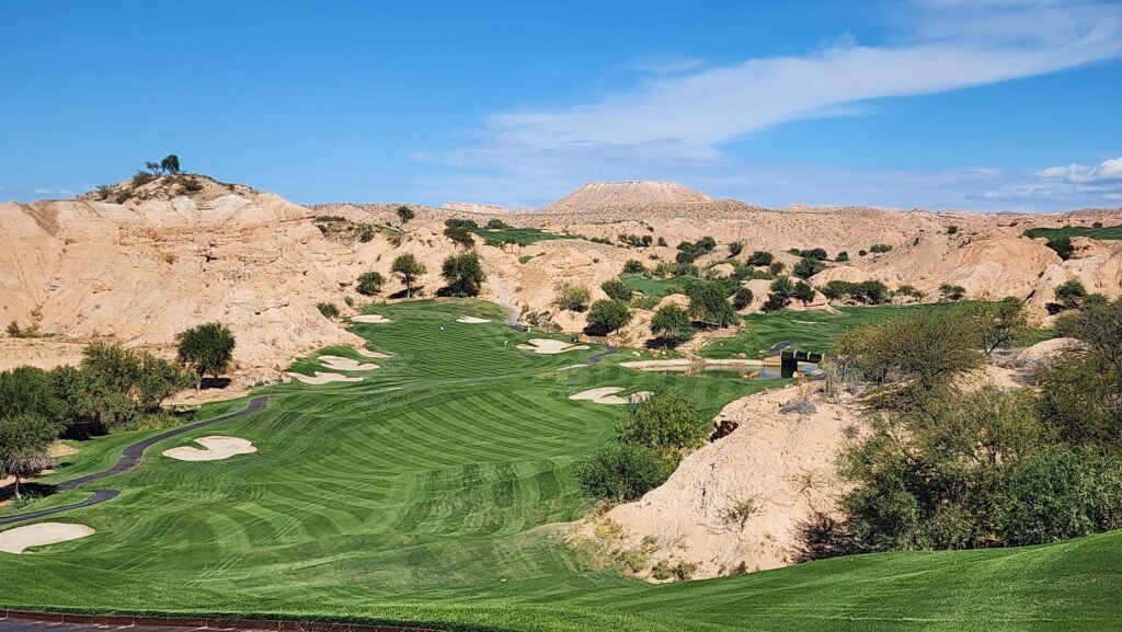 Fairway with mountains and bunkers.