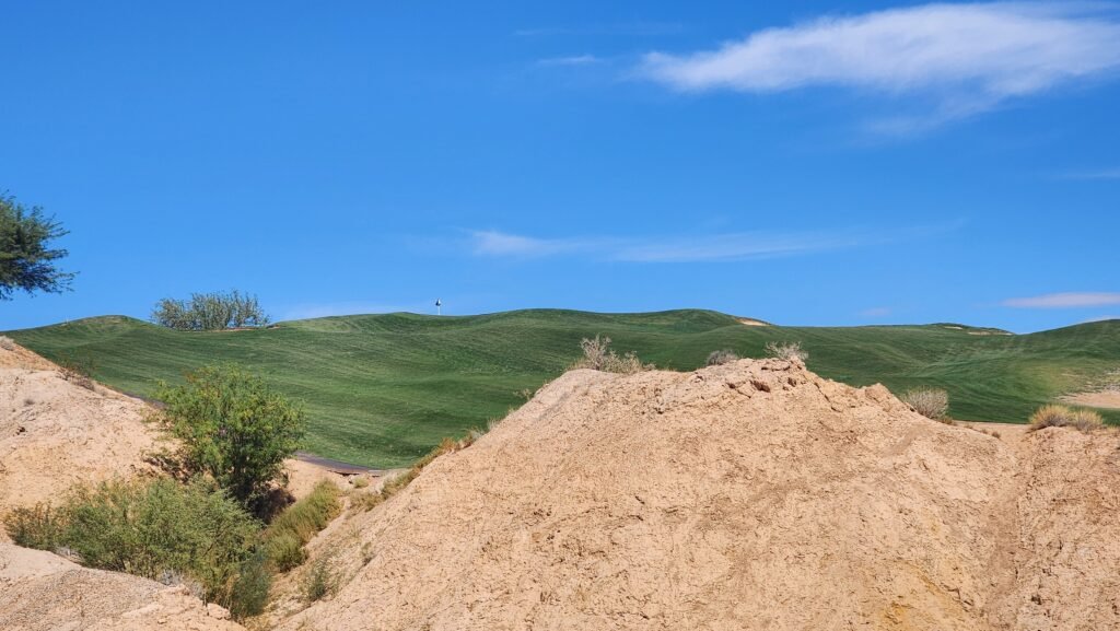 rocky points and fairway to a green with a flagstick