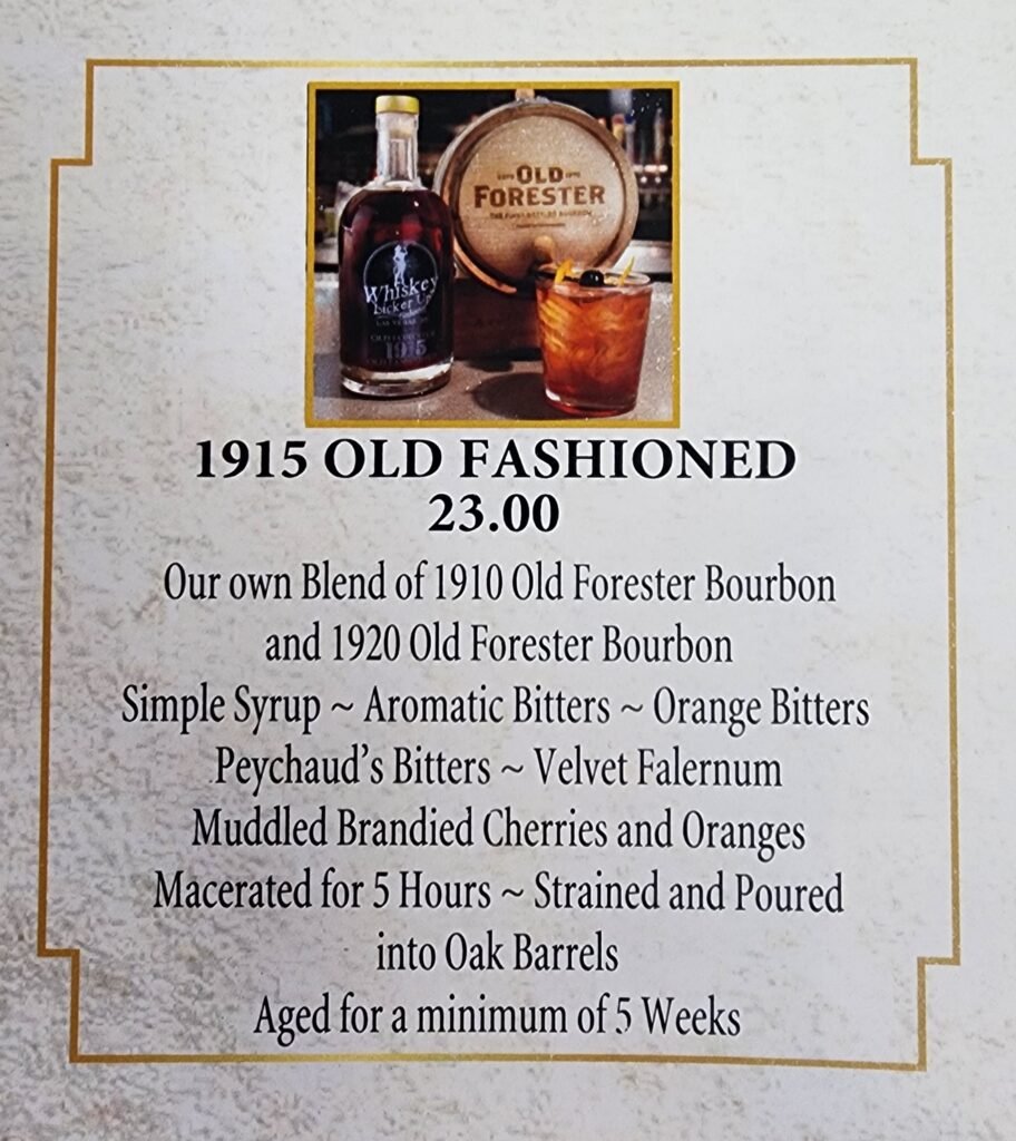 1915 old-fashioned with cocktail barrel and bottle