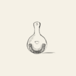 Hawthorne strainer for straining cocktail into a serving glass