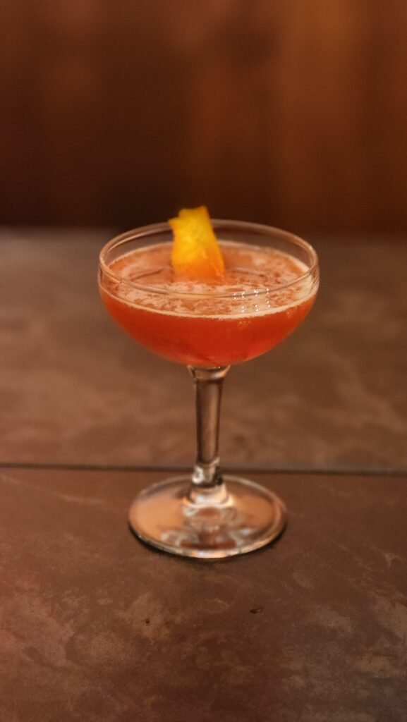 Campari Cocktail in a coup glass.