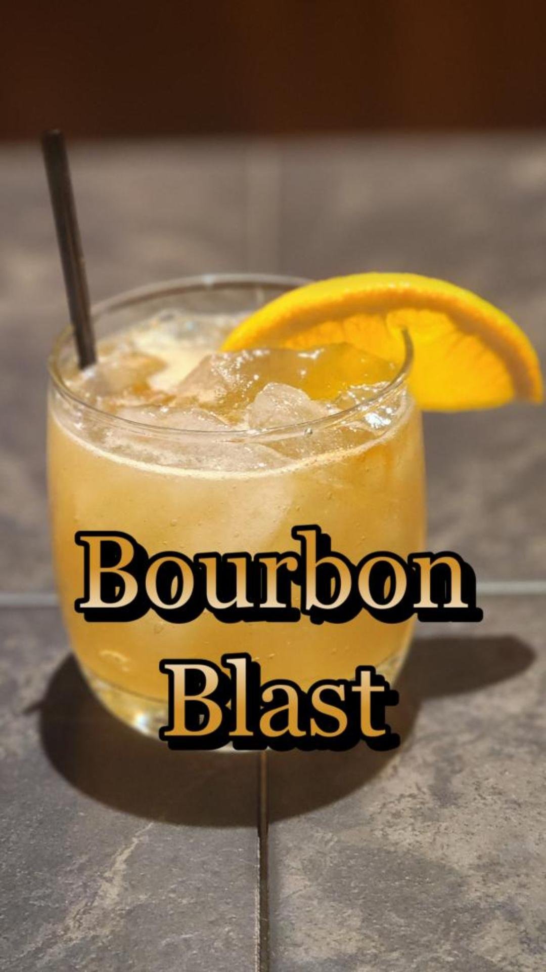 rocks glass with orange slice and straw